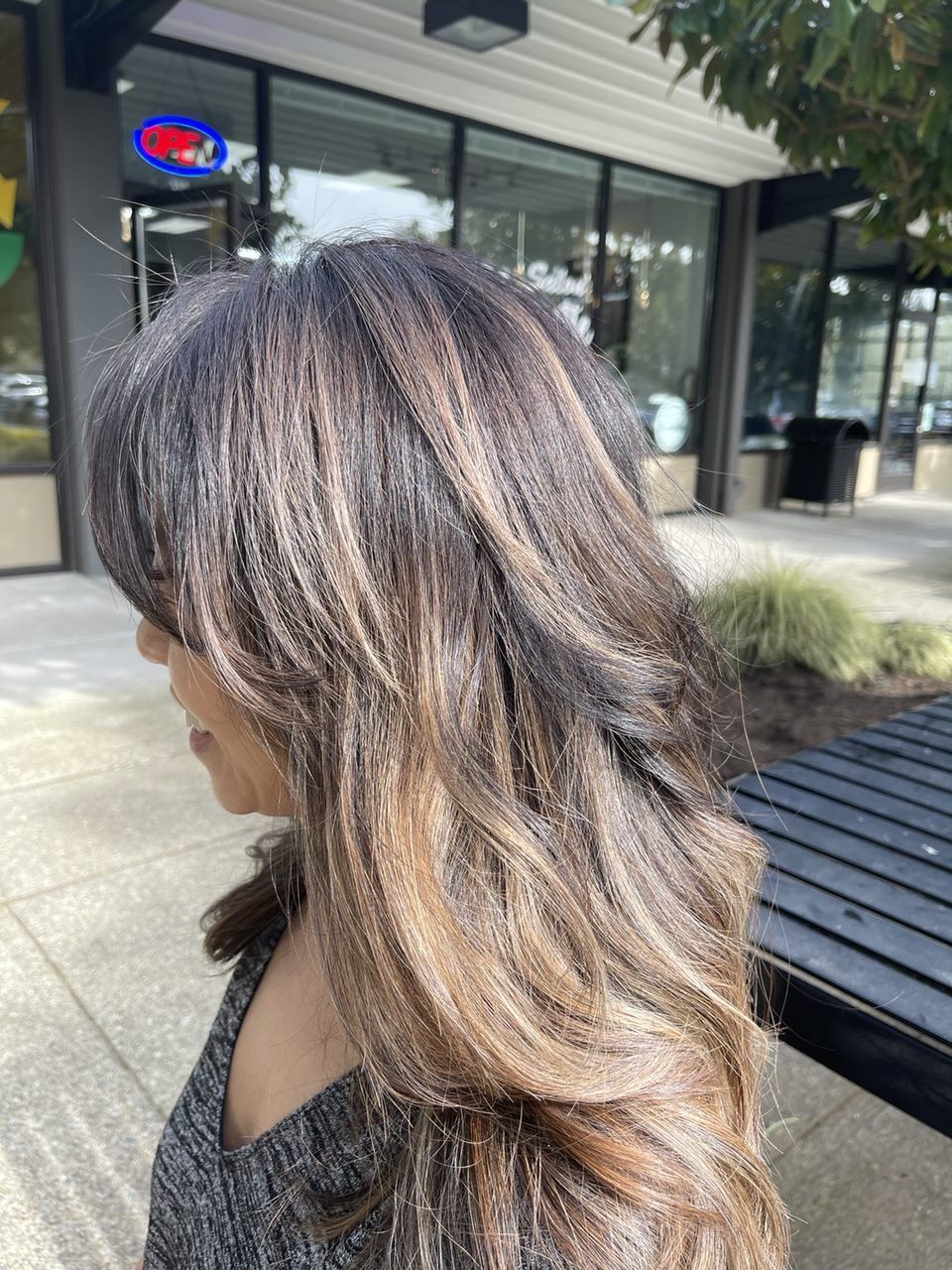 Long layered hair with caramel balayage and soft bangs