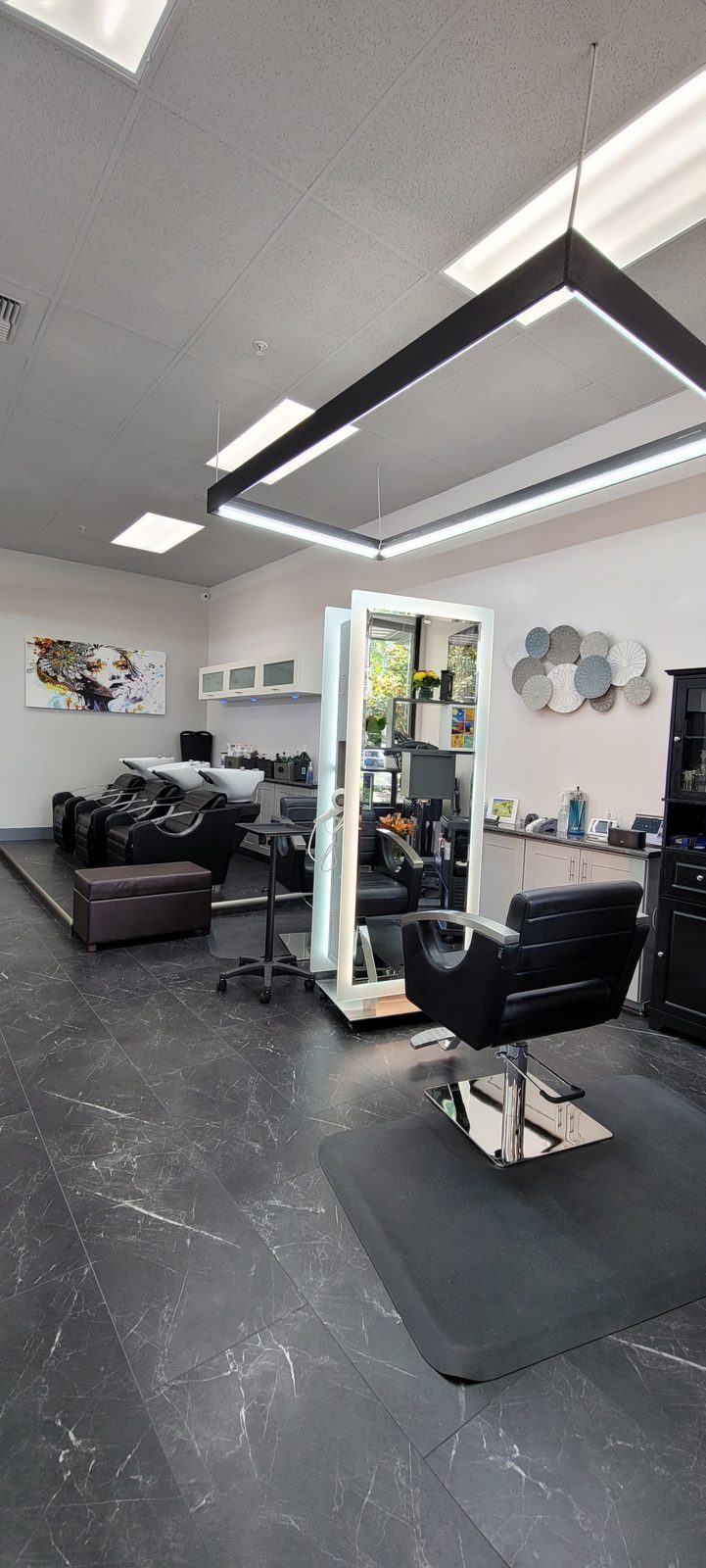 Styling stations and shampoo bowls inside Salon Monette